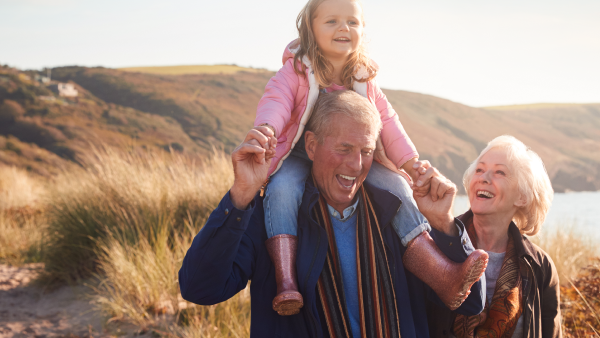 image of grandparents and grandchild on a walk