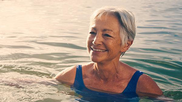 image of an older woman in the sea swimming