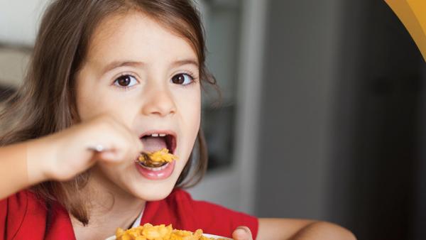 image of a young girl eating cereal