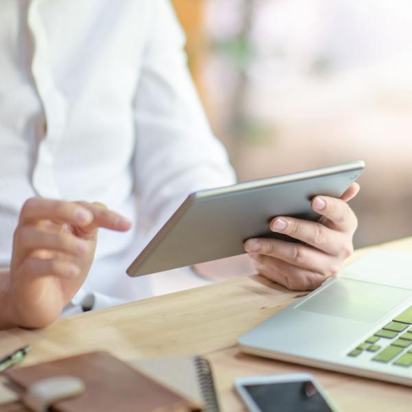 Man reading Glanbia Ireland Ingredients news on an iPad