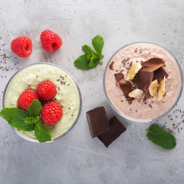 Two fresh dairy desserts in glasses from a top down angle