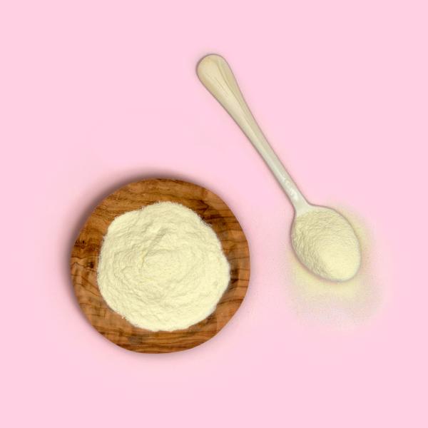 Bowl of Glanbia Ireland Ingredients Buttermilk Powder on Pink background