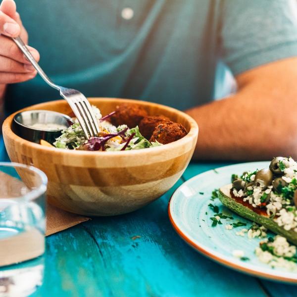 Man eating a vegan salad