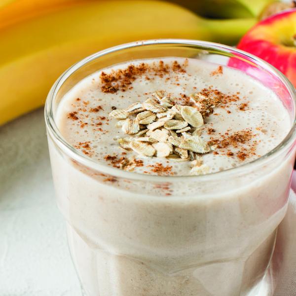 Static image featuring two bananas as well as the feature: a small bowl of porridge topped with oats.