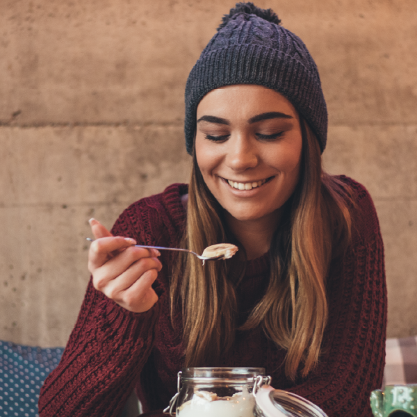 image of woman enjoying a yogurt 