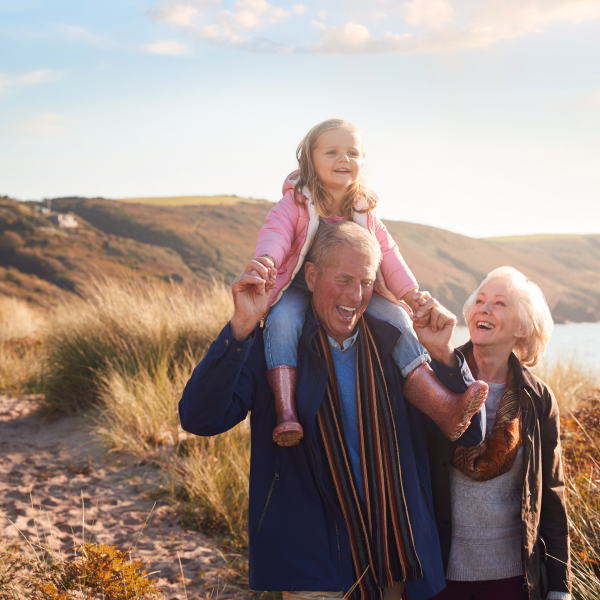 image of grandparents and grandchild on a walk