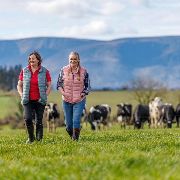 two farmers walking in field