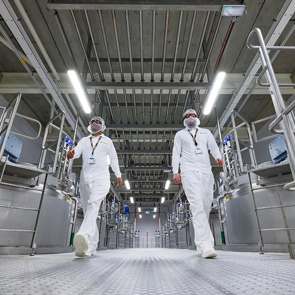 two factory workers walking in factoy