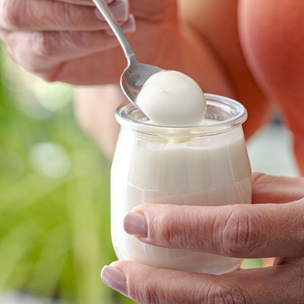 woman holding pot of yoghurt