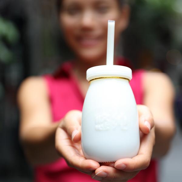 image of a woman holding a yoghurt