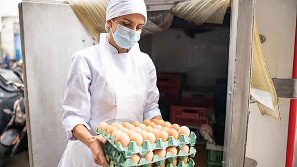 baker with cartons of eggs