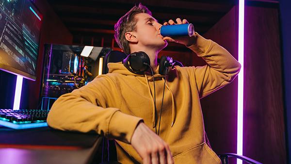 man drinking from can