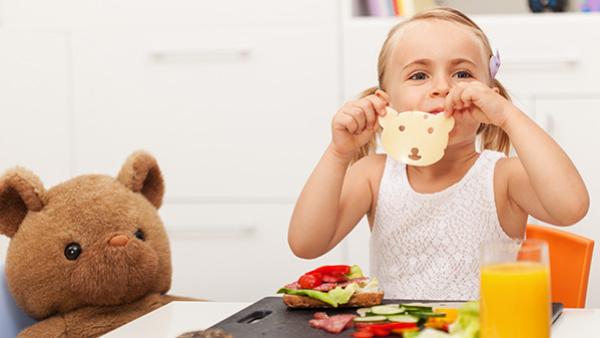 child eating cheese at kitchen table
