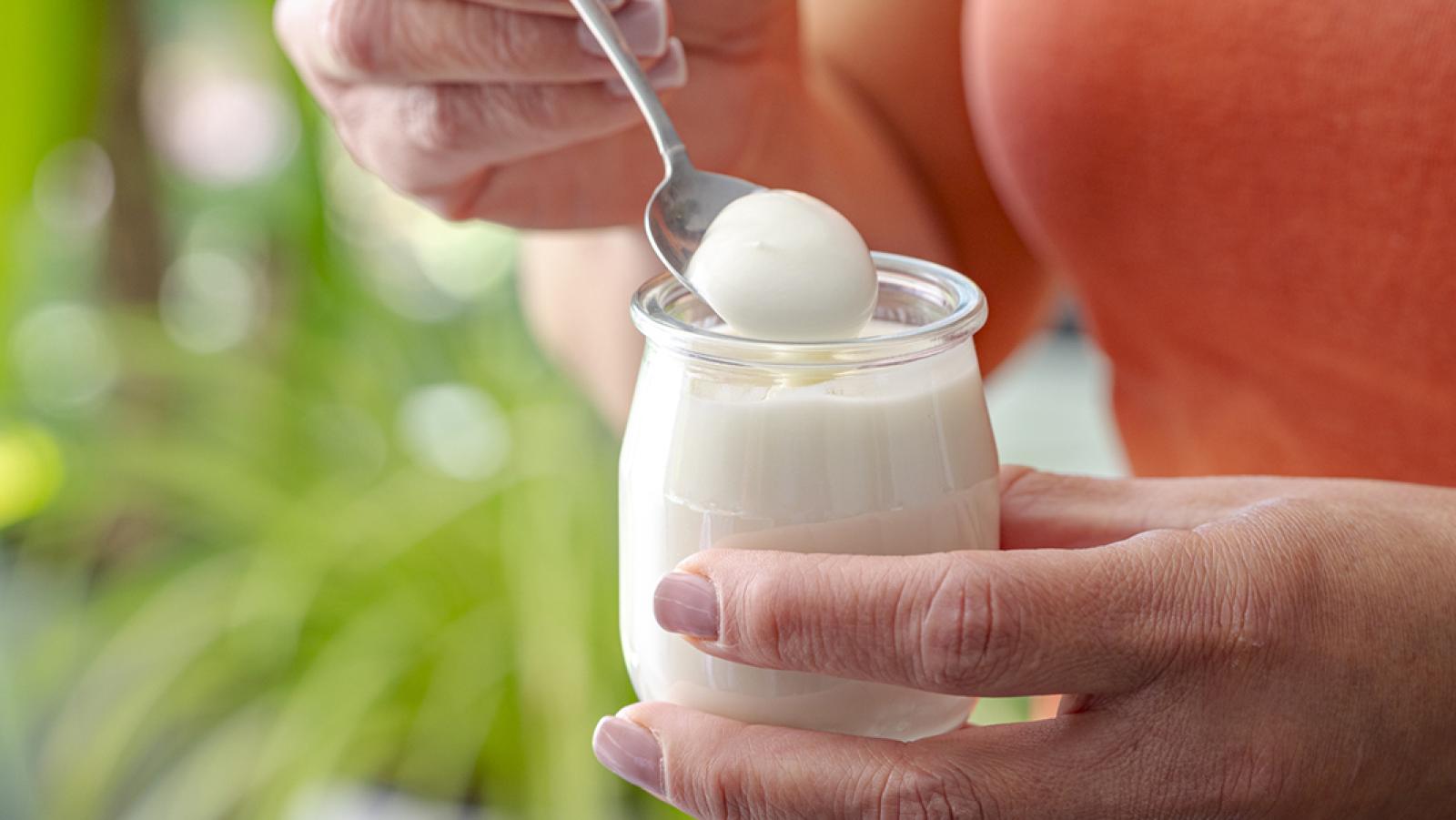 woman holding pot of yoghurt