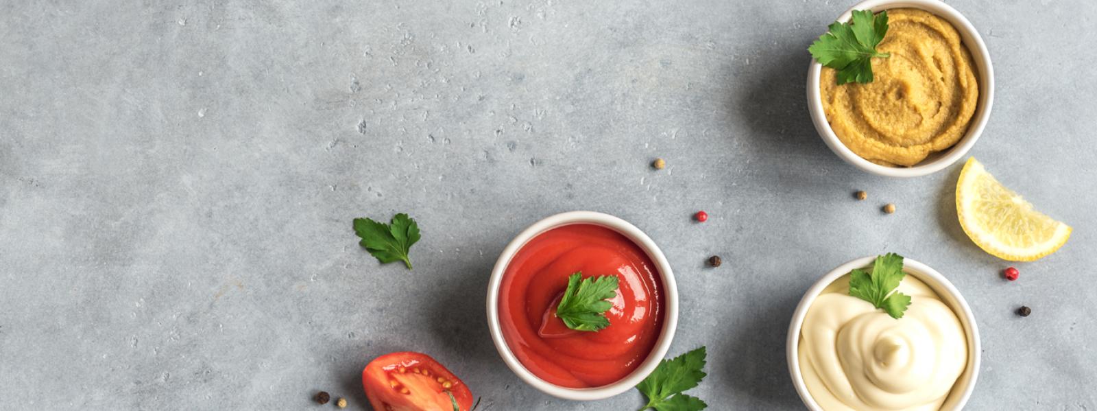 A selection of three dips on a slate background.